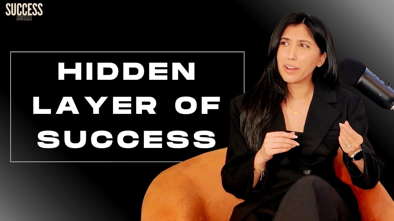 jag sat in orange podcast chair looking surprised at writing "hidden layer of success"